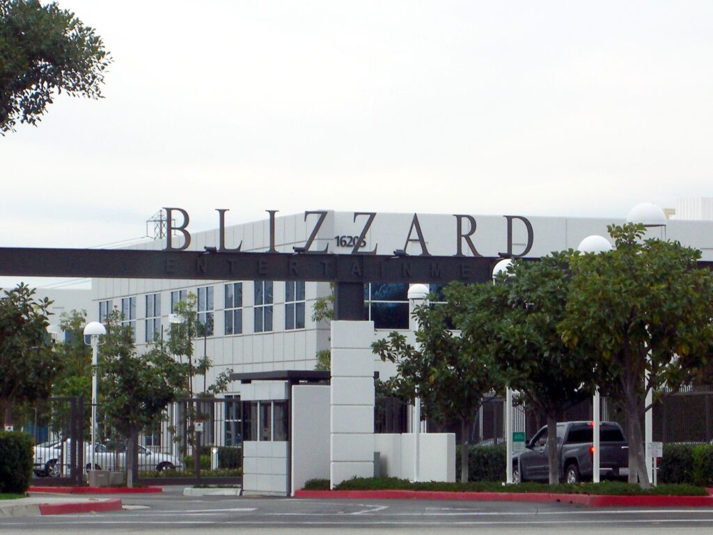 Exterior of the Blizzard Entertainment headquarters campus in Irvine, California, with the company name on a gantry sign above the entrance