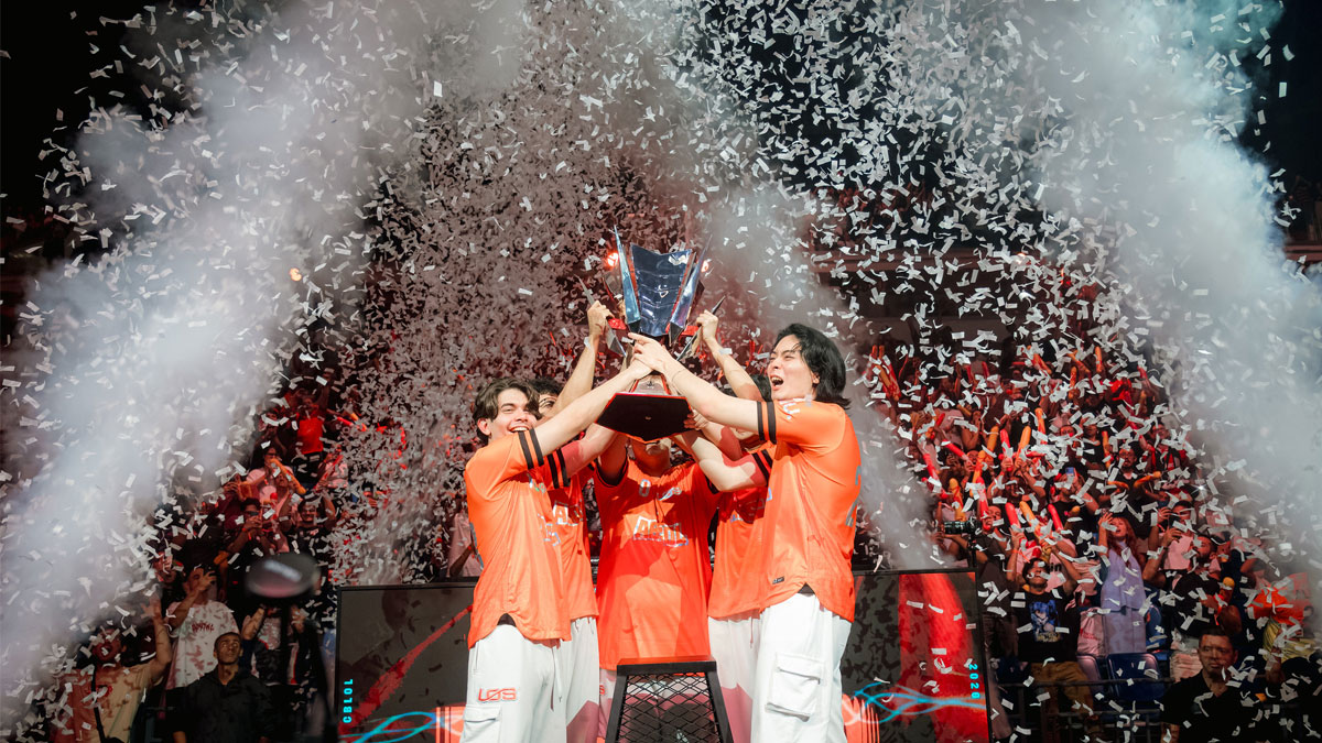 LOS players in orange jerseys lift the CBLOL championship trophy on stage amid falling confetti after beating FURIA in the CBLOL 2026 Split 2 Grand Final